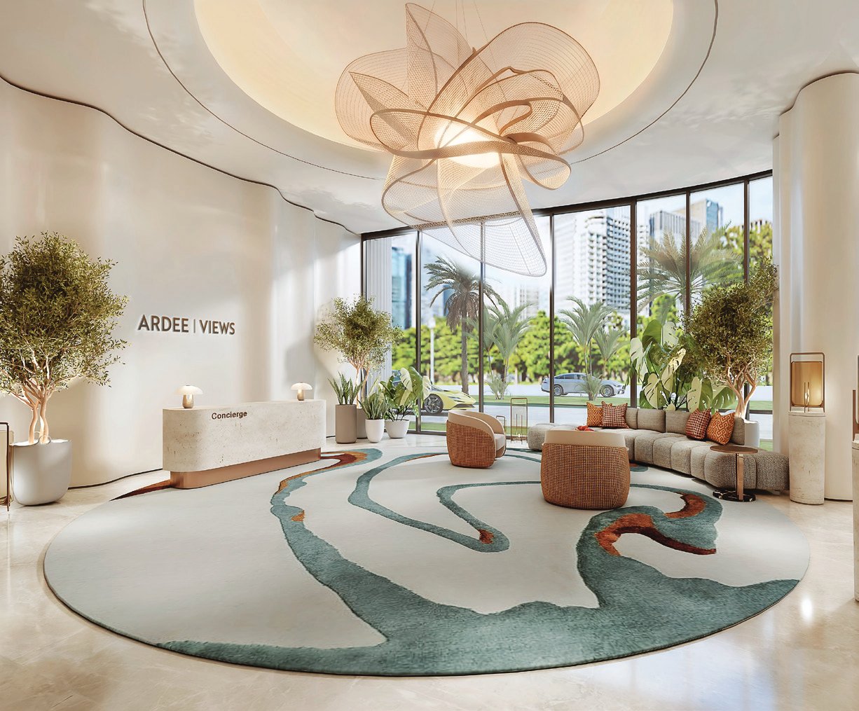 Bright lobby with sculptural ceiling light, concierge desk and garden views